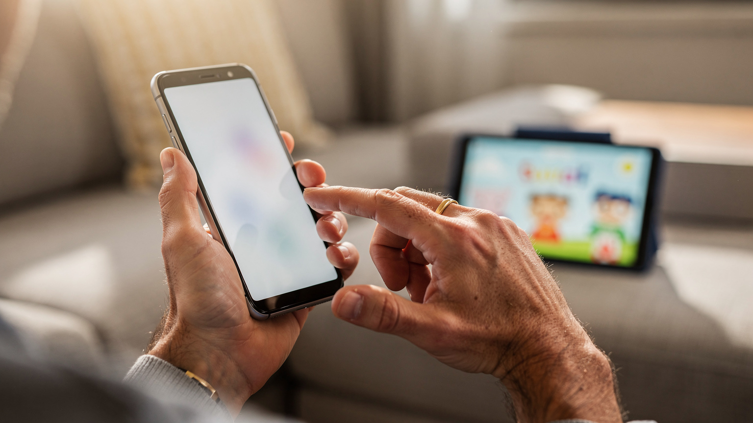 A parent's hands are shown close-up, expertly checking eSIM data usage on an older model Android phone, with a child happily watching a show on a tablet slightly out of focus in the background, set within a comfortable living room.